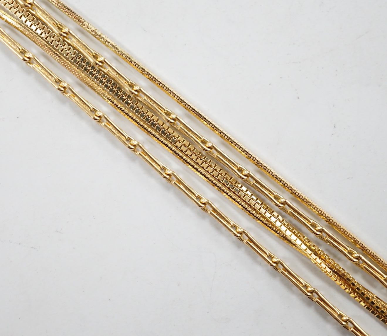 An 18ct gold fine baton link chain, 38cm and one other 750 chain, 7.3 grams and one 14kt chain, 0.9 grams.